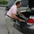 Deluxe Fly-Weight Aluminum Transport Chair with Removable Casters - Loading into Car